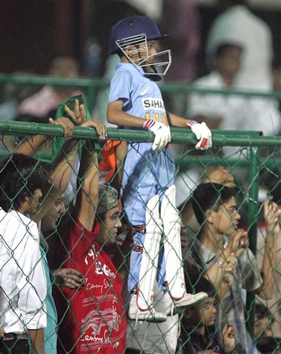 A young cricket fan fully dressed in players' gear watches Indias one day international cricket match against England for the ICC Champions Trophy in Jaipur on Sunday. ICC CT India-England