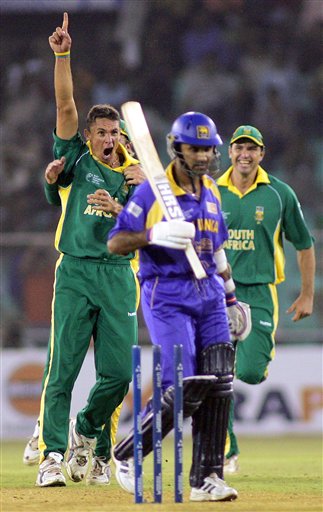 South African bowler Andre Nel, left, celebrates after Sri Lankan batsman Marvan Atapattu, center, was bowled by him during their match in the ICC Champions Trophy in Ahmadabad on Tuesday. ICC SA-SL