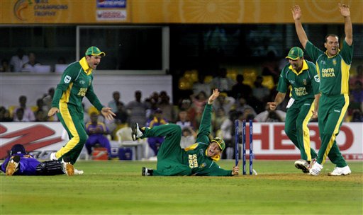 South Africa's Shaun Pollock, center, celebrates along with team mates after dismissing Sri Lanka's captain Mahela Jayawardene, left on ground, in the ICC Champions Trophy cricket tournament match in Ahmadabad on Tuesday. ICC SA-SL