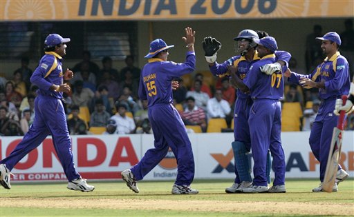 Sri Lankan team members congratulate Kumar Sangakkara, center right with gloves on, after he caught behind South Africa's Boeta Dippenaar, unseen, in their ICC Champions Trophy cricket tournament match in Ahmadabad on Tuesday. ICC SA-SL