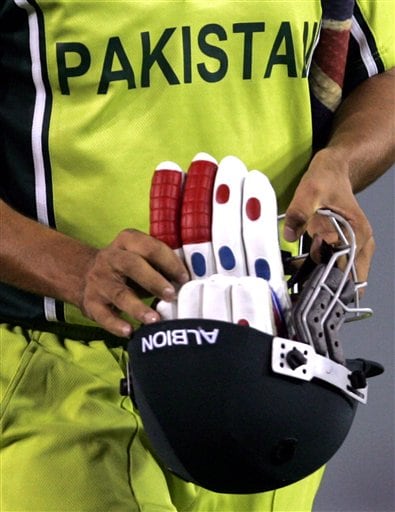 Pakistan's Younis Khan carries back his gloves and helmet after New Zealand's Kyle Mills took his wicket during the one day international cricket match for the ICC Champions Trophy in Mohali ICC CT NZ-Pak