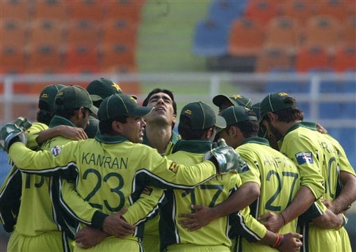 Pakistan's Umar Gul, center, looks up as he huddles together with teammates after the dismissal of South African Captain Graeme Smith, unseen, during their one-day international cricket match for the ICC Champions Trophy in Mohali on Friday. ICC CT Pak-SA