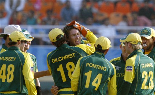 Australia's bowler Glenn McGrath, center, being congratulated by Adam Gilchrist (18) and team mates on the dismissal of India's Sachin Tendulkar, unseen during the one day international cricket match for the ICC Champions Trophy in Mohali on Sunday. ICC CT Ind-Aus