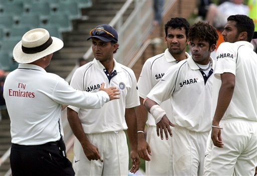 Umpire Mark Benson of England, left, has a word with India's bowler Shanthakumaran Sreesanth, second from right, and teammates after taunting South Africa's batsman Hashim Amla, unseen, on his dismissing during the third day of the 1st cricket test match between South Africa and India at the Wanderers stadium in Johannesburg, South Africa. Ind-SA 1st Test Day 3