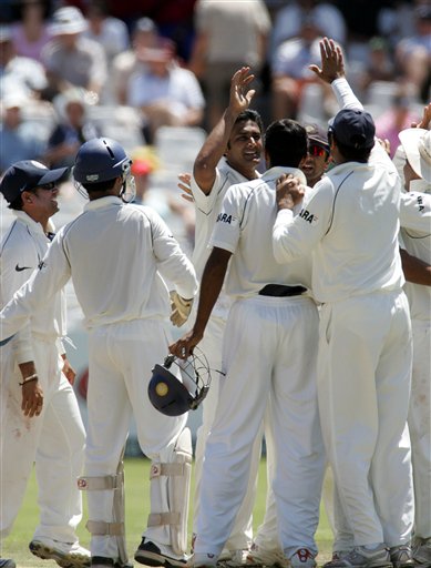 South Africa's batsman Graeme Smith, left, watches his shot as India's fielder VVS Laxman, right, looks on during the third day of the 3rd and final Test match against India at Newlands stadium in Cape Town, South Africa, Thursday. Ind-SA 3rd Test Day 3