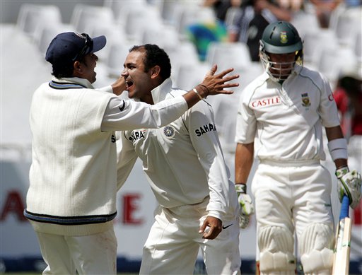 India's bowler Virender Sehwag, center, celebrates with teammate Sachin Tendulkar, left, after dismissing South Africa's batsman Herschelle Gibbs, right, for 7 runs after a successfully appeal for a LBW on the third day of the 3rd and final Test match against South Africa at Newlands stadium in Cape Town, South Africa, Thursday. Ind-SA 3rd Test Day 3