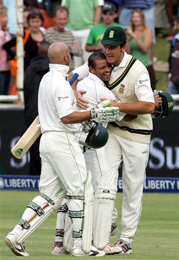 South Africa's captain Graeme Smith, right, congratulates teammates batsman Ashwell Prince, center, and Herschelle Gibbs, after scoring the winning runs on the final day of the 3rd and final Test match against India at Newlands stadium in Cape Town Ind-SA 3rd Test Day 5