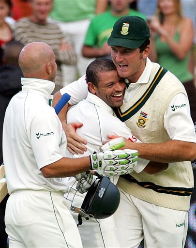 South Africa's captain Graeme Smith, right, congratulates teammates batsman Ashwell Prince, center, and Herschelle Gibbs, after scoring the winning runs on the final day of the 3rd and final Test match against India at Newlands stadium in Cape Town Ind-SA 3rd Test Day 5