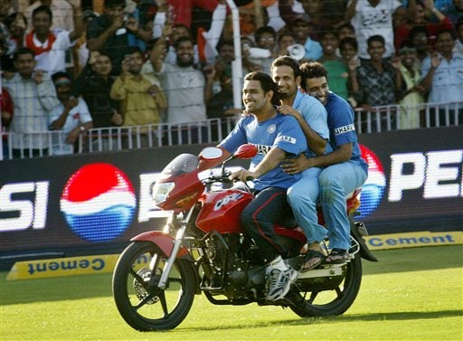 Indian cricketers Mahendra Singh Dhoni, left, Irfan Pathan, center, and Robin Uthappa ride a bike in joy after India beat West Indies in the fourth one-day international cricket match in Vadodara, India. Ind-WI 4th ODI