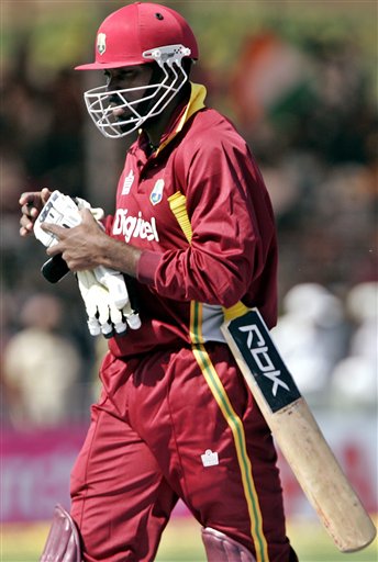 West Indies batsman Chris Gayle leaves the ground after India's Ajit Agarkar, unseen, took his wicket during the fourth one day international cricket match in Vadodara, India. Ind-WI 4th ODI