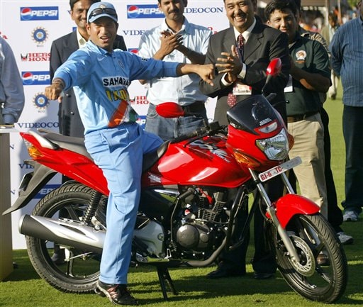 Indian cricketer Sachin Tendulkar sits on a bike he received as Man of the Match award after India won the fourth one-day international cricket match against West Indies in Vadodara, India Ind-WI 4th ODI