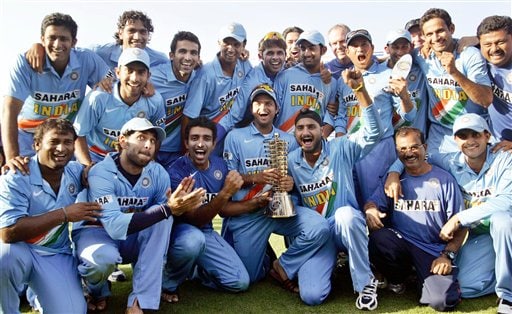 Members of the Indian cricket team pose with the winner's trophy after beating West Indies in the fourth one-day international cricket match in Vadodara, India. Ind-WI 4th ODI