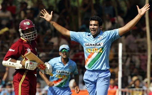 India's Zaheer Khan, right and Rahul Dravid, center, celebrate the dismissal of West Indies Shivnaraine Chanderpaul, left during the fourth one day international cricket match in Vadodara, India. Ind-WI 4th ODI