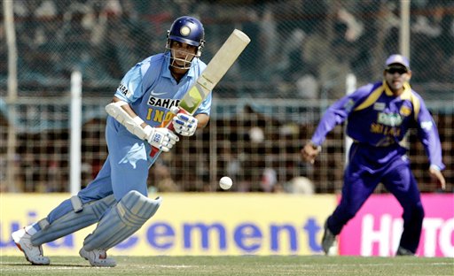 Indian cricketer Sourav Ganguly, left, plays a shot as Sri Lanka's Tillakaratne Dilshan looks on during the second one-day international in Rajkot, India, Sunday, February 11, 2007. Ind-SL 2nd ODI