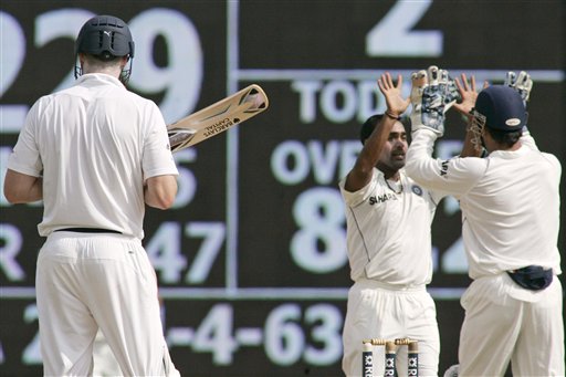 India's Amit Mishra and MS Dhoni celebrate the dismissal of England's Andrew Flintoff during second day of the first Test match between India and England in Chennai on Friday.(AP Photo) India vs England: 1st Test, Day 2