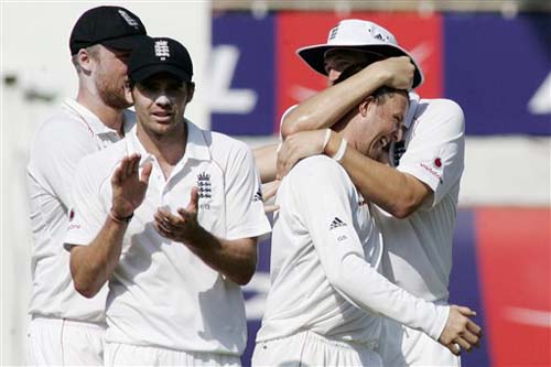 England's Steve Harmison embraces Graeme Swann as teammates James Anderson and Andrew Flintoff celebrate the dismissal of Rahul Dravid during the second day of the first Test between India and England in Chennai on Friday. (AP Photo) India vs England: 1st Test, Day 2