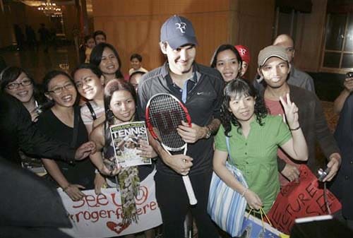 Swiss Roger Federer poses with fans after a press conference in Kuala Lumpur, Malaysia on Monday. Showdown of champions