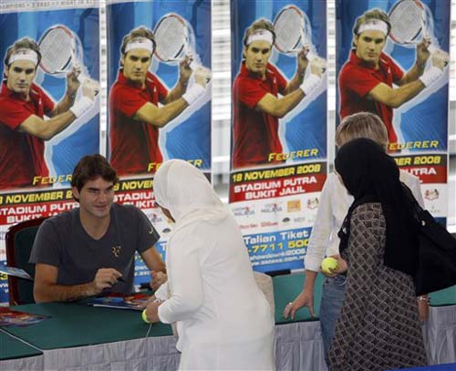 Roger Federer reacts as he meets the fans in Kuala Lumpur on Tuesday. Federer will play against James Blake in an exhibition match later on Tuesday. Showdown of champions