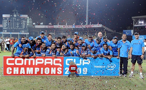Indian cricketers pose for photographers after their victory in the Tri-Nation Championship trophy final ODI match between India and Sri Lanka at the R. Premadasa Stadium in Colombo on September 14, 2009. India won by 46 runs. (AFP Photo) India win Compaq Cup 2009