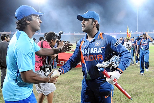 Sri Lankan captain Kumar Sangakkara is congratulated by Indian captain MS Dhoni after victory in the Tri-Nation Championship trophy final ODI match at the R. Premadasa Stadium in Colombo on Monday. (AFP Photo) India win Compaq Cup 2009
