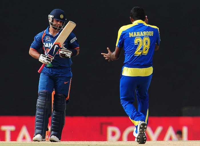 Farveez Maharoof celebrates the dismissal of Indian cricketer Virat Kohli (L) during the sixth ODI of the Asia Cup between Sri Lanka and Indian at the Rangiri Dambulla International Cricket stadium in Dambulla. (AFP Photo) Asia Cup: Ind vs SL