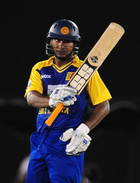 Kumar Sangakkara raises his bat to the crowd after scoring a half-century during the sixth ODI of the Asia Cup between Sri Lanka and Indian at the Rangiri Dambulla International stadium in Dambulla. (AFP Photo) Asia Cup: Ind vs SL