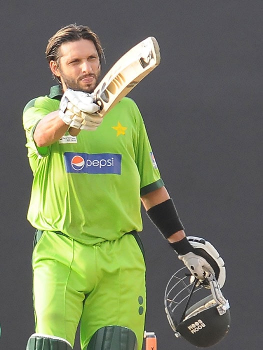 Shahid Afridi raises his bat in celebration after scoring a century (100 runs) during the fifth ODI of the Asia Cup between Pakistan and Bangladesh at the Rangiri Dambulla International Cricket stadium in Dambulla. (AFP Photo) Asia Cup: Pak vs B'desh