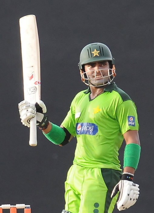 Umar Akmal raises his bat to the crowd after scoring a half-century (50 runs) during the fifth ODI of the Asia Cup between Pakistan and Bangladesh at the Rangiri Dambulla International Cricket stadium in Dambulla. (AFP Photo) Asia Cup: Pak vs B'desh