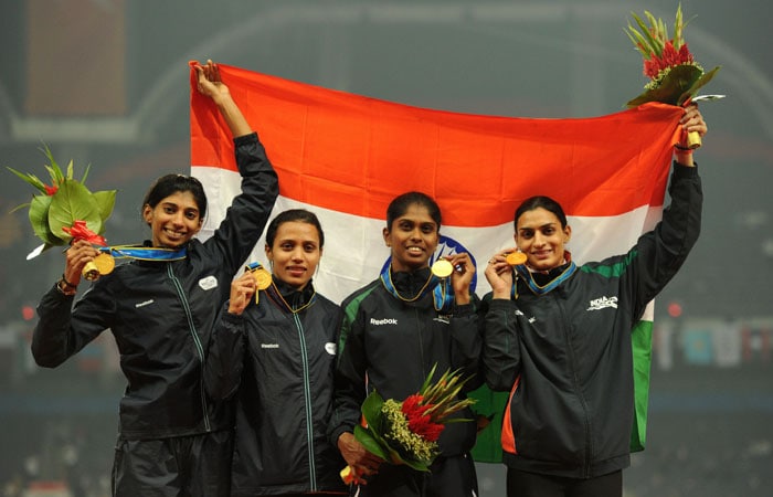 The Indian women's 4x400 relay team, Manjeet Kaur, Shi Jose, Ashwini Chidananda Akkunji and Mandeep Kaur, listen to their national anthem on the podium during the award ceremony for the women's 4x400m relay in the athletics competition at the 16th Asian Games in Guangzhou. India won gold, Kazakhstan took silver and China the bronze. (AFP Photo)