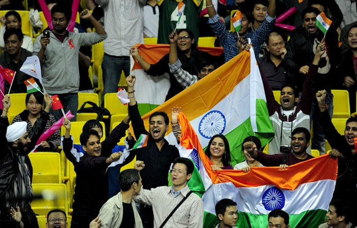 Indian fans celebrate for Vijender Singh after Singh beats Abbos Atoev of Uzbekistan during the men's 75kg boxing final competition at the 16th Asian Games in Guangzhou. (AFP Photo)