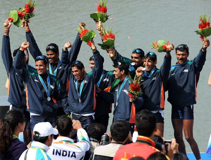 Members of the Indian rowing team celebrate with friends and teammates following the medals ceremony for the men's eight final during the 16th Asian Games in Guangzhou. (AFP Photo)