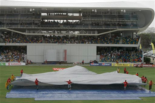 Groundkeepers cover the wicket during a rainfall on the opening day of the third and final cricket Test match between the West Indies and Australia at Kensington Oval in Bridgetown on Thursday, June 12, 2008. West Indies restricted Australia to 226 for seven at close on a rain-shortened first day. 3rd Test, Australia vs West Indies, Day 1