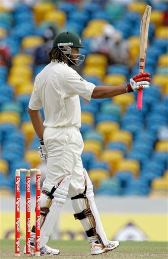 Andrew Symonds raises his bat to celebrate a half-century on the opening day of the third and final cricket Test match against West Indies in Bridgetown on Thursday, June 12, 2008. 3rd Test, Australia vs West Indies, Day 1