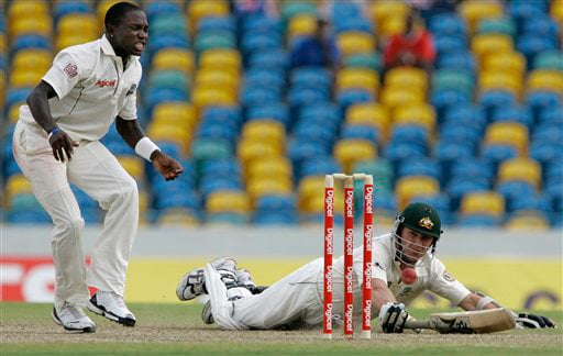 West Indies' fast bowler Fidel Edwards, left, reacts while watching the ball missing to hit the stumps in an attempt to run out Australia's batsman Brett Lee on the opening day of their third and final cricket Test match in Bridgetown on Thursday, June 12, 2008. 3rd Test, Australia vs West Indies, Day 1