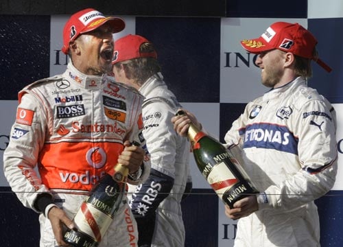 McLaren Mercedes Formula One driver Lewis Hamilton of Britain, left, is sprayed with champagne by runner up BMW Sauber driver Nick Heidfeld of Germany after winning the Australian Grand Prix in Melbourne on Sunday March 16, 2008. Hamilton won the race in front of Heidfeld and Williams Formula One driver Nico Rosberg of Germany. F 1: Australian Grand Prix