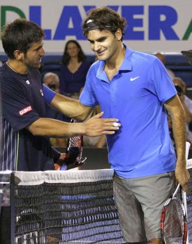Switzerland's Roger Federer, right, greets Serbia's Janko Tipsarevic at the net after winning their third round Men's Singles match at the Australian Open tennis championships in Melbourne on Saturday, January 19, 2008. Day 6: Australian Open