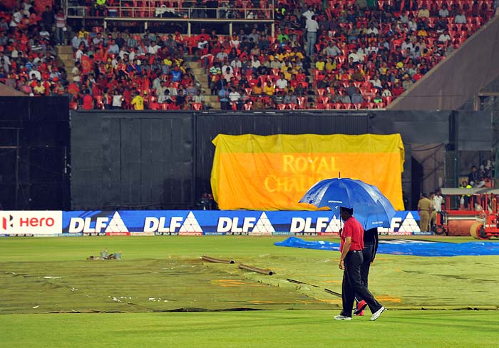 The pitch was a batting heaven according to reports but was kept under cover due to the showers. (AFP PHOTO/Manjunath KIRAN) IPL: Another day, another washout as Bangalore, Chennai share points