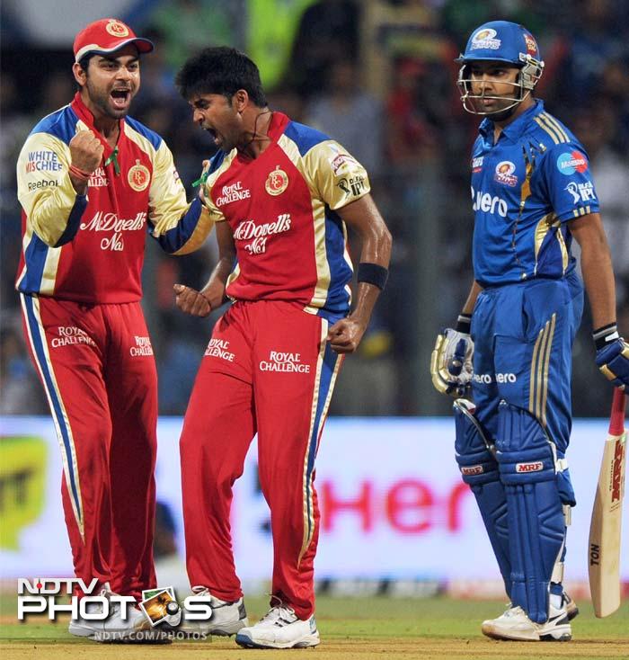 It was a sad start for Mumbai as R Vinay Kumar (c) got two early breaks when he removed James Franklin and Rohit Sharma (right) in a single over. (AFP PHOTO/Indranil MUKHERJEE) IPL 5: Bangalore clobber Mumbai by 9 wickets