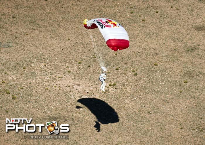 The veteran skydiver was in freefall for four minutes and 20 seconds before opening his red and white parachute and floating down to the desert in the US state of New Mexico, said Red Bull Stratos mission record keeper Brian Utley.