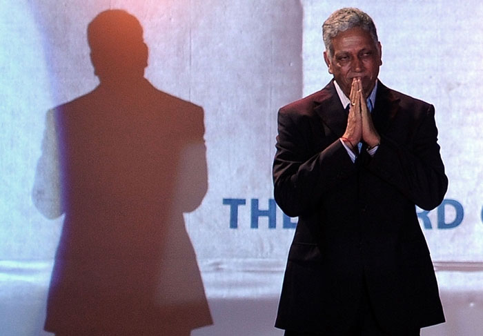 Mohinder Amarnath greets the audience as he arrives on stage to receive the CK Naydu trophy lifetime achievement award for contribution to Indian cricket at the BCCI annual award function in Mumbai. (AFP Photo) BCCI honours Sachin for cricketing excellence