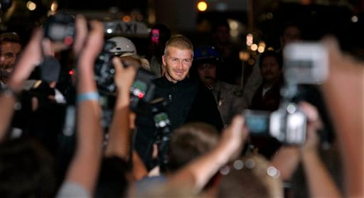 Beckham smiles at photographers as he arrives at Los Angeles International Airport. Beckhams arrive in LA