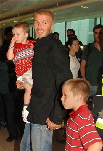 Beckham with his sons Cruz and Brooklyn, right. Beckhams arrive in LA