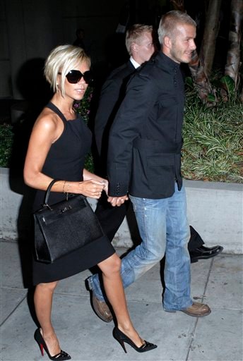 Beckham holds his wife Victoria's hand. Beckhams arrive in LA