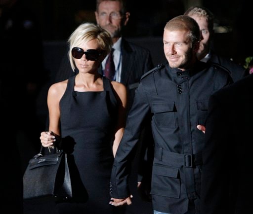 Beckham holding his wife's hand Victoria arrive at Los Angeles International Airport while Angelinos look. Beckhams arrive in LA