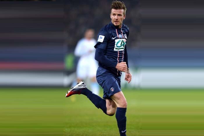 David Beckham controls the ball in front Marseille's French midfielder Andre Pierre Gignac at the the Parc des Princes stadium in Paris. David Beckham shows his mettle in first full-game for Paris St Germain