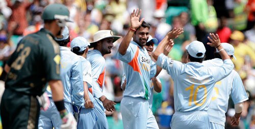 Praveen Kumar, fourth right, celebrates with teammates after taking the wicket of Adam Gilchrist during the first final of their tri-nations one-day international series at the Sydney Cricket Ground on Sunday, March 2, 2008. First final - India vs Australia
