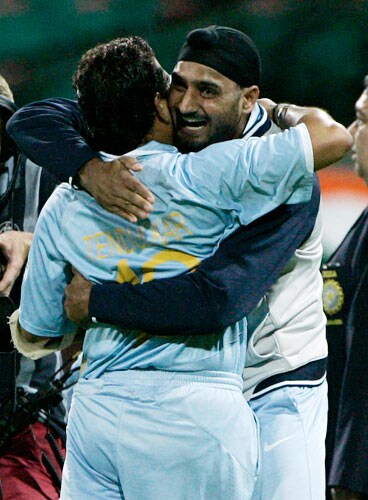 Sachin Tendulkar, left, and MS Dhoni celebrate after India won the first final of their tri-nations one-day international series against Australia in Sydney on Sunday, March 2, 2008. India won by six wickets with Tendulkar not out for 117 runs. First final - India vs Australia