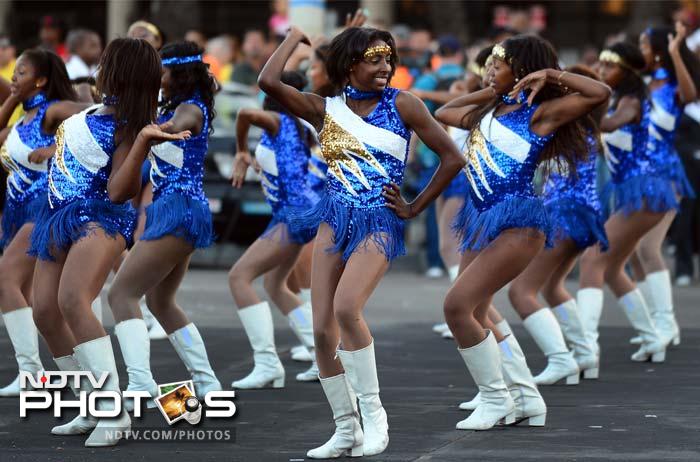 Cheerleaders from Crenshaw High School entertain the crowd awaiting the passing of the US space shuttle Endeavour on its way through city streets on its way to a permanent home at the California Science Center in Los Angeles, on October 13.