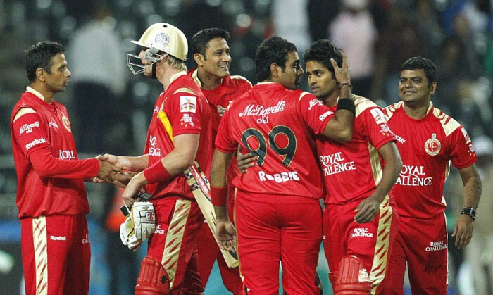Royal Challengers Bangalore's Rahul Dravid congratulates teammate Cameron White for scoring the winning run at the end of the Champions League Twenty20 match against Highveld Lions at the Wanderers Stadium in Johannesburg. (AP Photo) CLT20: India all the way