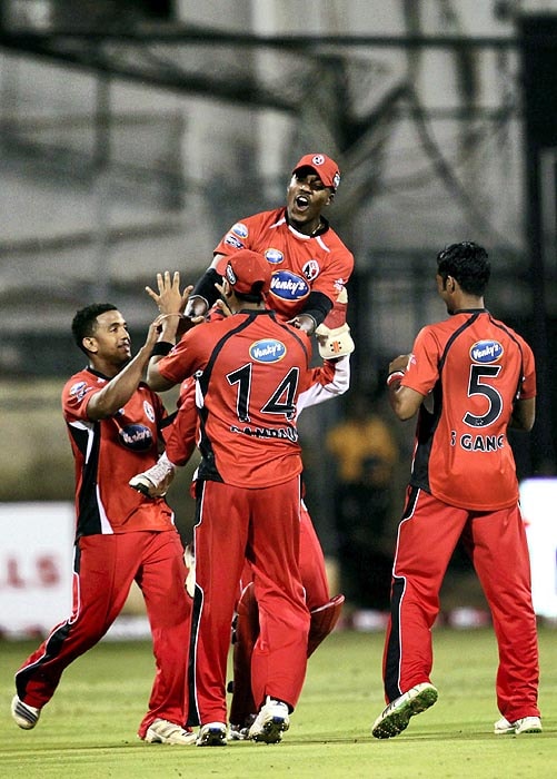 Trinidad and Tobago players celebrate the fall of the wicket of a Somerset batsman during their Champions League T20 match at Chinnaswamy Stadium in Bangalore on Monday. (PTI Photo) CLT20: T&T vs Somerset